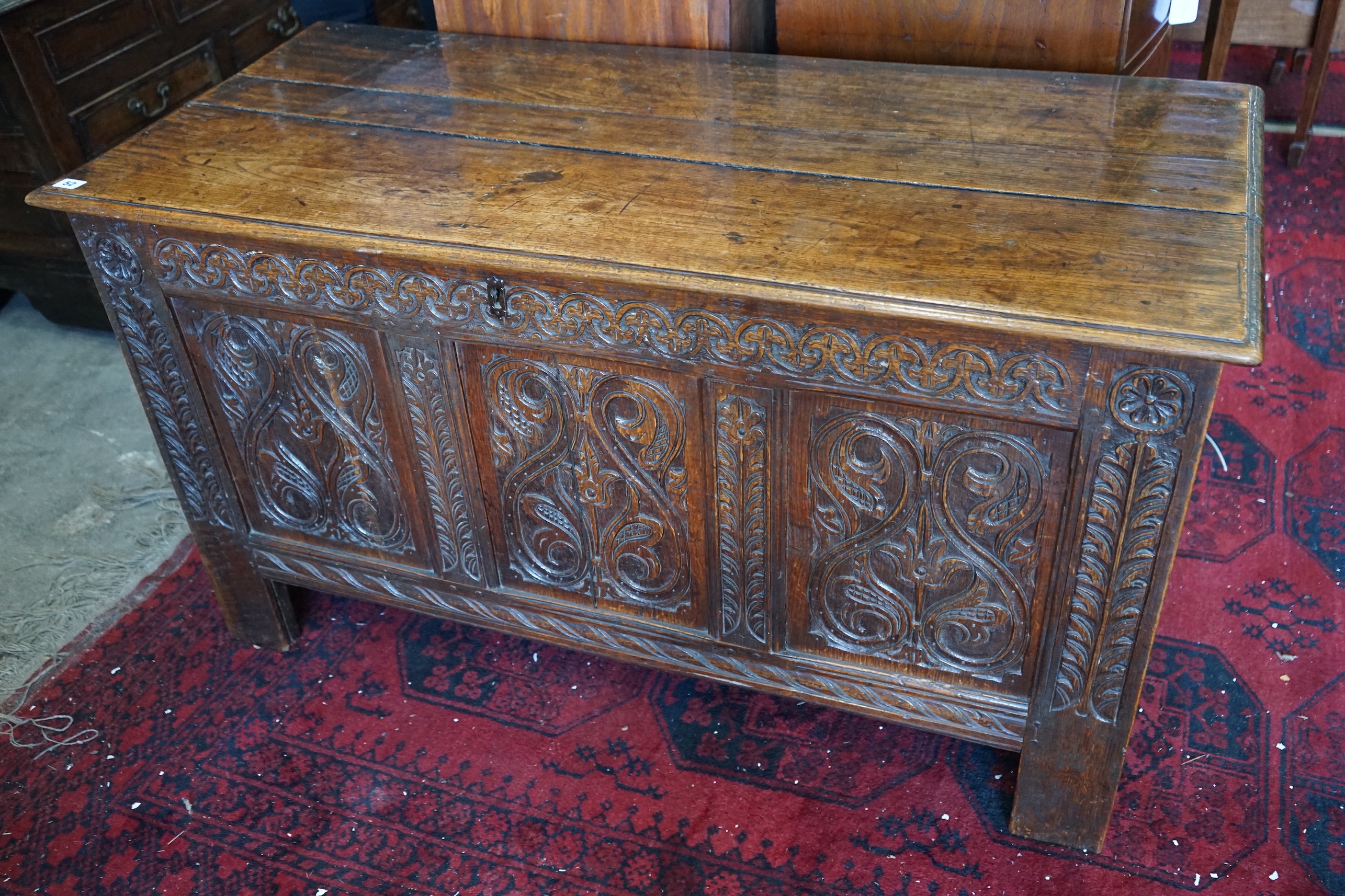 A late 17th /early 18th century carved oak panelled coffer, length 128cm, depth 58cm, height 72cm